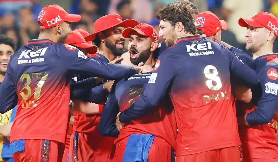 Virat Kohli and other RCB players celebrating after a wicket
